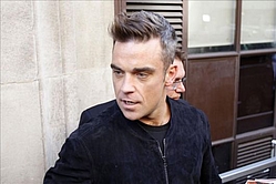 Robbie Williams: `Getting married helped me lose my rubbish`