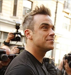 Robbie Williams stays quiet about `embarrassing` mystery illness