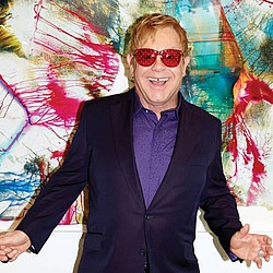 Elton John surprises with train station performance