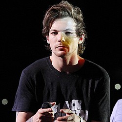Louis Tomlinson buzzing about baby
