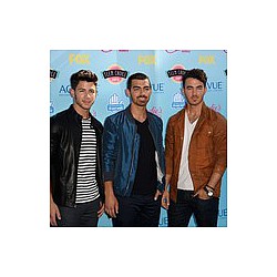 Jonas Brothers laugh at Miley