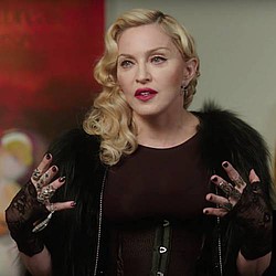 Madonna returns with child