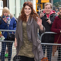 Red-faced Meghan Trainor falls victim to her six-inch heels