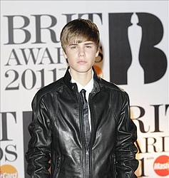 Justin Bieber sneaks a kiss from Cheryl Cole at Brits