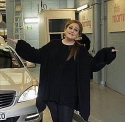 Adele holds on to number one UK single and album