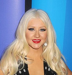 Christina Aguilera pops out of dress