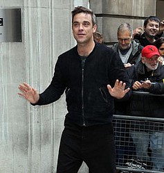 Robbie Williams` dangly bits pop out at gig