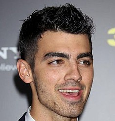 Joe Jonas swamped by girls at birthday pool party