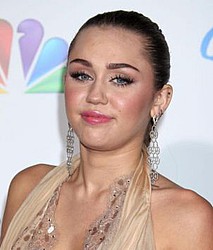 Miley Cyrus denies boob job rumours