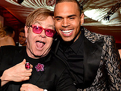 Chris Brown Says He&#039;s &#039;Different&#039; Now, Embraced By Elton John At Oscar Party