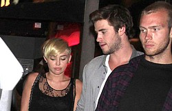 Miley Cyrus and Liam Hemsworth working through problems
